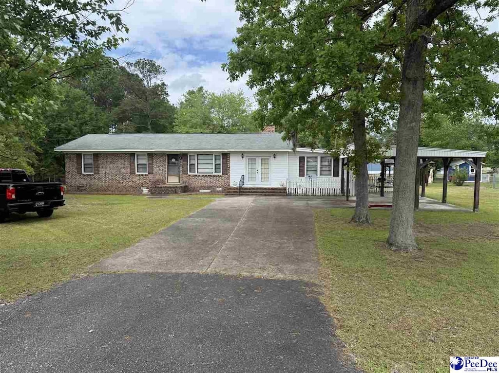 1816 Southern Acres Loop, Dillon, SC 29536 - single story home featuring driveway, french doors, a front yard, and brick siding