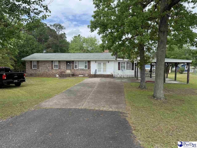 1816 Southern Acres Loop, Dillon, SC 29536 - single story home featuring driveway, french doors, a front yard, and brick siding