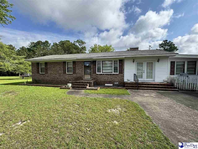 1816 Southern Acres Loop, Dillon, SC 29536 - single story home with french doors, brick siding, and a front lawn
