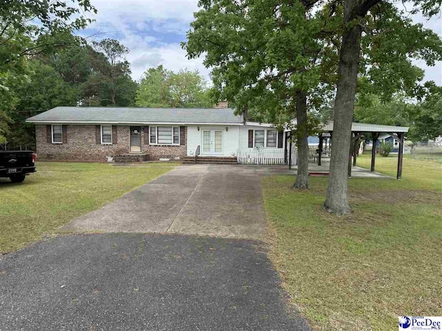 1816 Southern Acres Loop, Dillon, SC 29536 - ranch-style house featuring asphalt driveway, a front yard, french doors, and brick siding