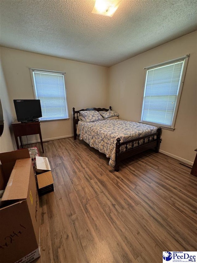 1816 Southern Acres Loop, Dillon, SC 29536 - bedroom featuring wood finished floors and a textured ceiling
