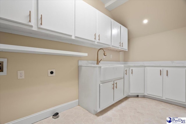 clothes washing area with cabinets, electric dryer hookup, hookup for a washing machine, and sink