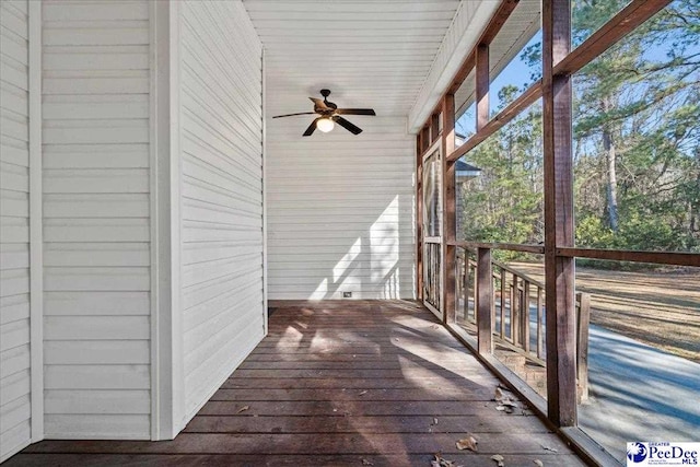 unfurnished sunroom featuring ceiling fan