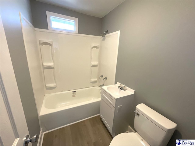 full bath featuring vanity, shower / tub combination, toilet, and wood finished floors