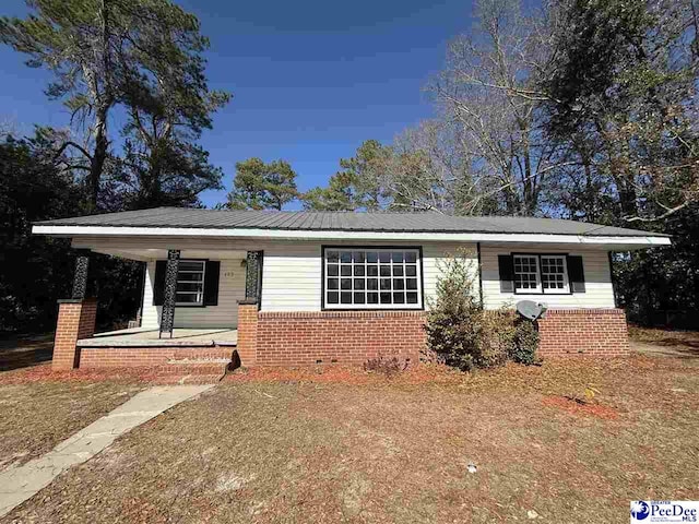 view of front of property with brick siding and covered porch