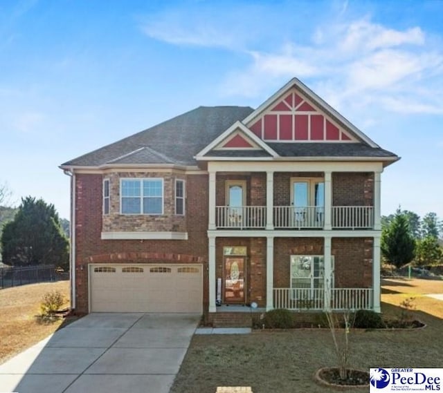 view of front of home with a garage, a balcony, and covered porch