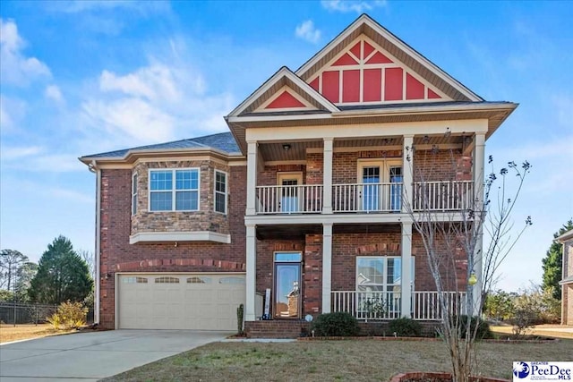 craftsman-style home with a garage, a balcony, and covered porch