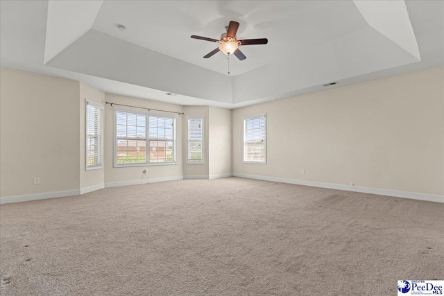 1635 Lake Wateree Dr, Florence, SC 29501 - spare room featuring ceiling fan, carpet floors, baseboards, and a raised ceiling
