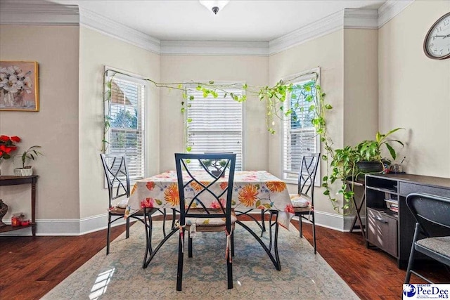 dining space with dark wood-type flooring and ornamental molding