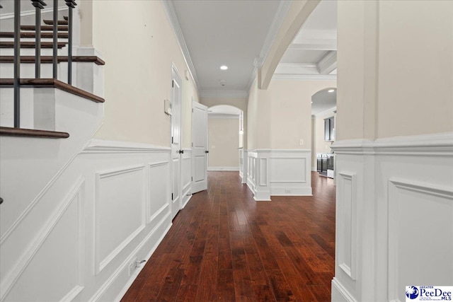 1635 Lake Wateree Dr, Florence, SC 29501 - hall featuring arched walkways, dark wood finished floors, wainscoting, a decorative wall, and ornamental molding