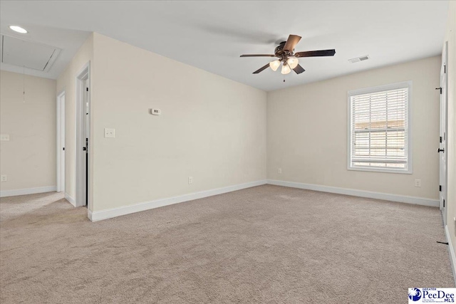 1635 Lake Wateree Dr, Florence, SC 29501 - empty room featuring visible vents, a ceiling fan, light carpet, baseboards, and attic access