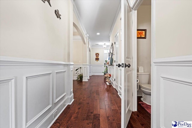 corridor featuring ornamental molding and dark hardwood / wood-style floors