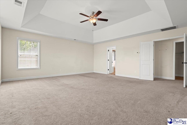 1635 Lake Wateree Dr, Florence, SC 29501 - carpeted empty room featuring visible vents, baseboards, a ceiling fan, and a tray ceiling
