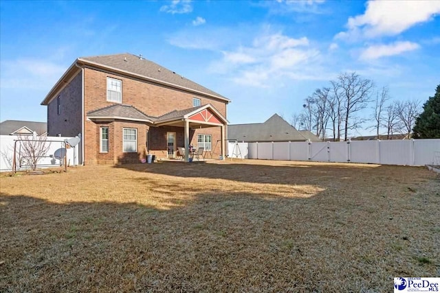 rear view of house with a yard