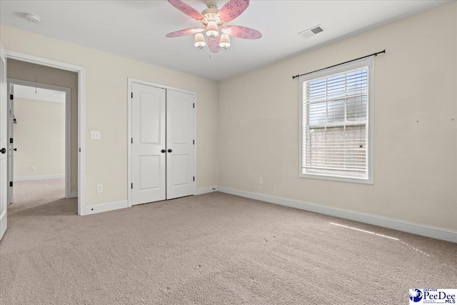 1635 Lake Wateree Dr, Florence, SC 29501 - unfurnished bedroom featuring a ceiling fan, a closet, carpet, baseboards, and visible vents