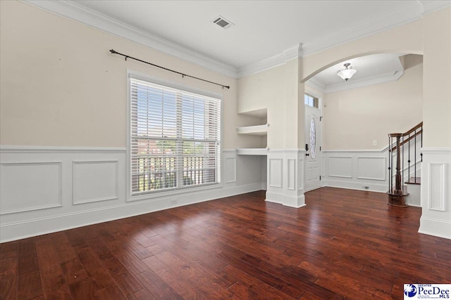 1635 Lake Wateree Dr, Florence, SC 29501 - unfurnished room featuring hardwood / wood-style flooring, arched walkways, visible vents, and a decorative wall