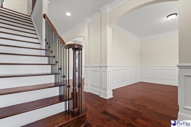 1635 Lake Wateree Dr, Florence, SC 29501 - staircase with wainscoting, arched walkways, ornamental molding, and wood finished floors
