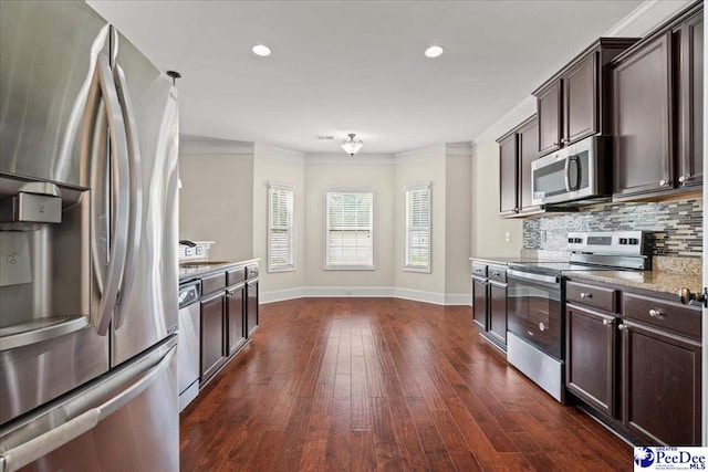 1635 Lake Wateree Dr, Florence, SC 29501 - kitchen featuring stainless steel appliances, backsplash, dark brown cabinets, crown molding, and dark wood-style flooring