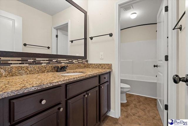 1635 Lake Wateree Dr, Florence, SC 29501 - full bathroom featuring toilet, bathtub / shower combination, visible vents, backsplash, and vanity