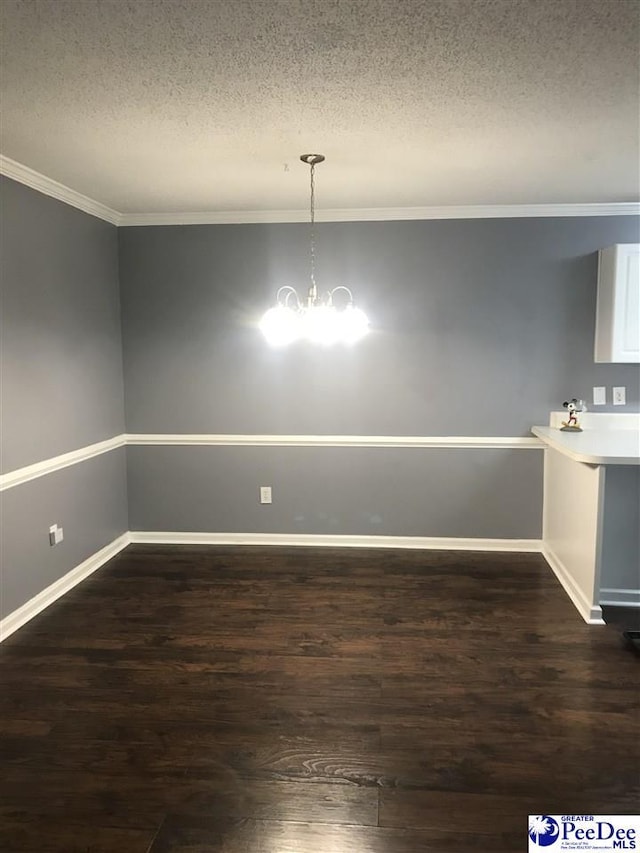 1424 Golf Terrace Blvd, Florence, SC 29501 - unfurnished dining area featuring a textured ceiling, dark wood finished floors, ornamental molding, and a chandelier