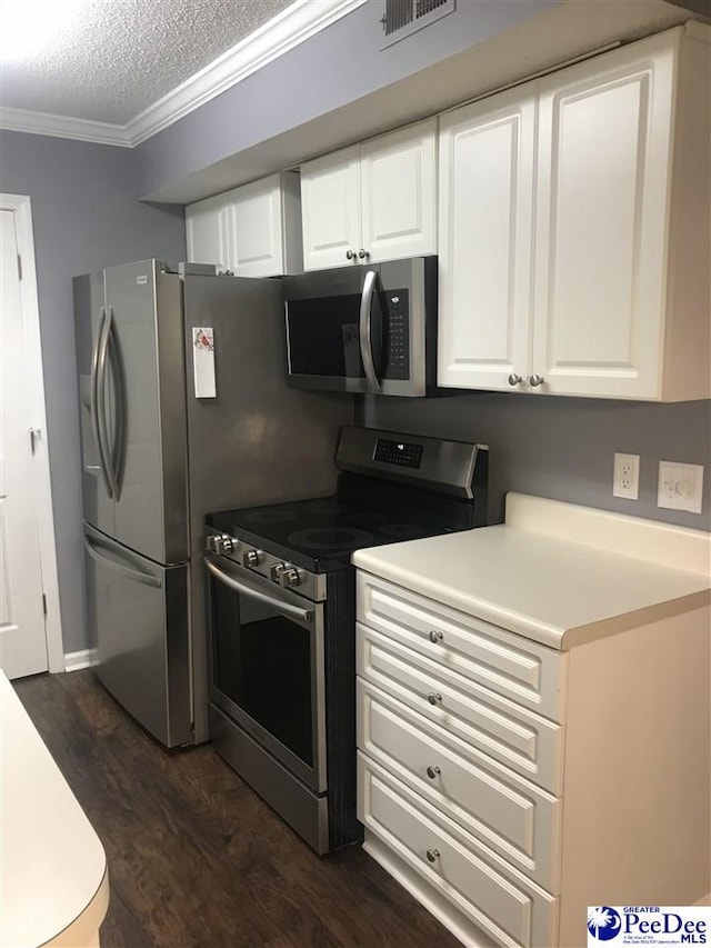 1424 Golf Terrace Blvd, Florence, SC 29501 - kitchen with appliances with stainless steel finishes, crown molding, dark wood-type flooring, white cabinetry, and a textured ceiling