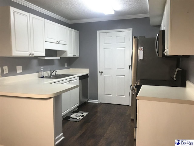 1424 Golf Terrace Blvd, Florence, SC 29501 - kitchen featuring appliances with stainless steel finishes, white cabinets, dark wood-type flooring, a textured ceiling, and ornamental molding