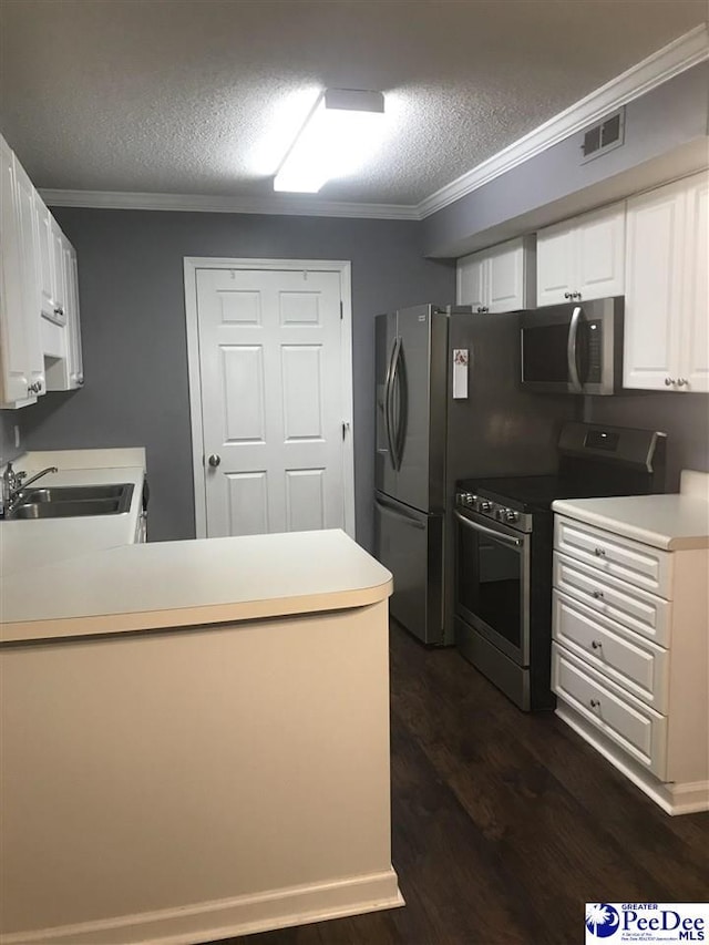1424 Golf Terrace Blvd, Florence, SC 29501 - kitchen with appliances with stainless steel finishes, ornamental molding, dark wood finished floors, a textured ceiling, and a peninsula