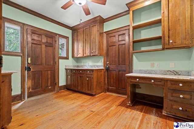 kitchen featuring ceiling fan, crown molding, brown cabinets, and light wood-type flooring