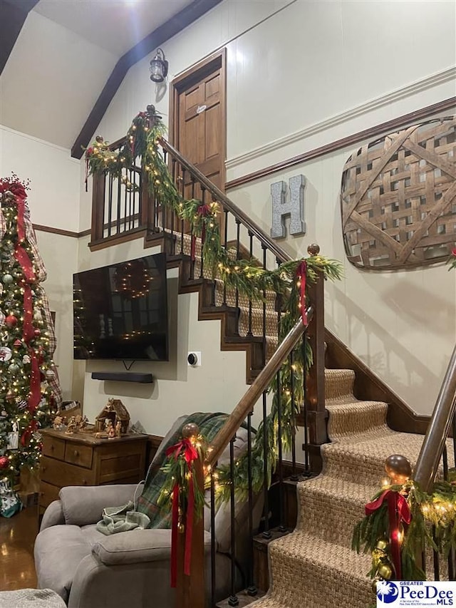 staircase featuring vaulted ceiling