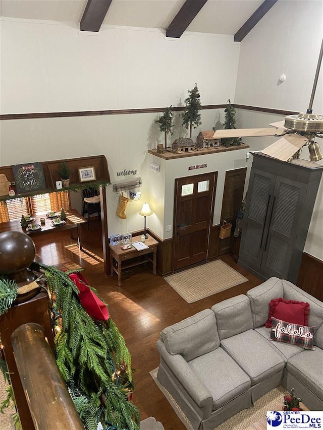 living room with dark hardwood / wood-style flooring and beam ceiling