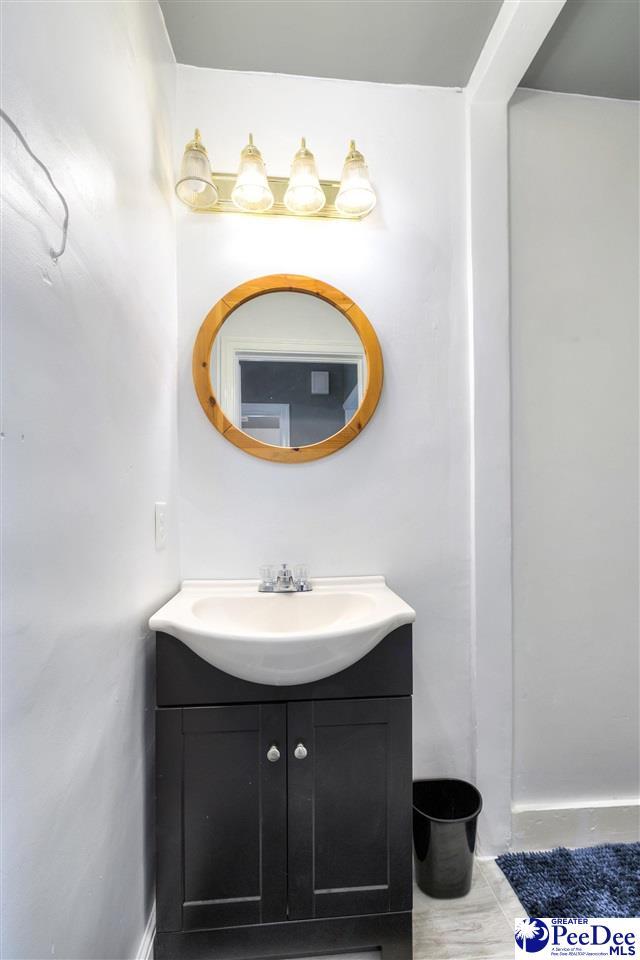 bathroom featuring baseboards and vanity