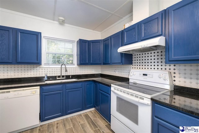kitchen with blue cabinets, a sink, backsplash, white appliances, and under cabinet range hood