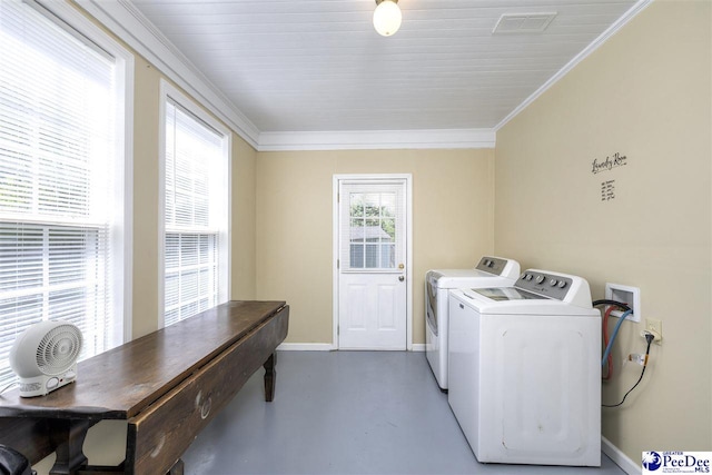 washroom featuring crown molding, laundry area, washing machine and dryer, baseboards, and visible vents