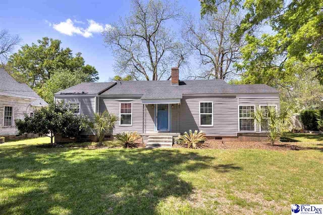 view of front of home featuring crawl space, a front lawn, and a chimney