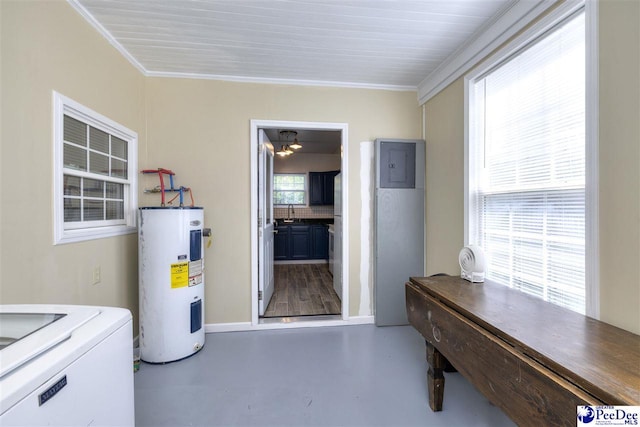 interior space featuring electric water heater, ornamental molding, a sink, concrete floors, and washer / clothes dryer