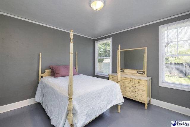 bedroom with baseboards and crown molding