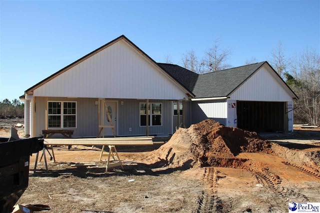 view of front facade featuring a porch and a garage