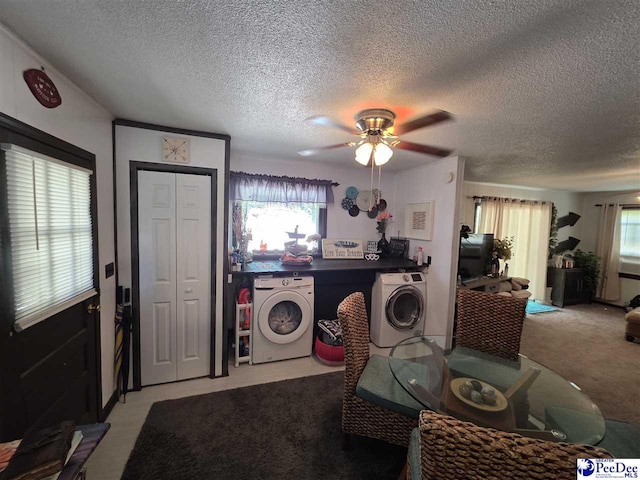 laundry area with a healthy amount of sunlight, washer and dryer, ceiling fan, and a textured ceiling