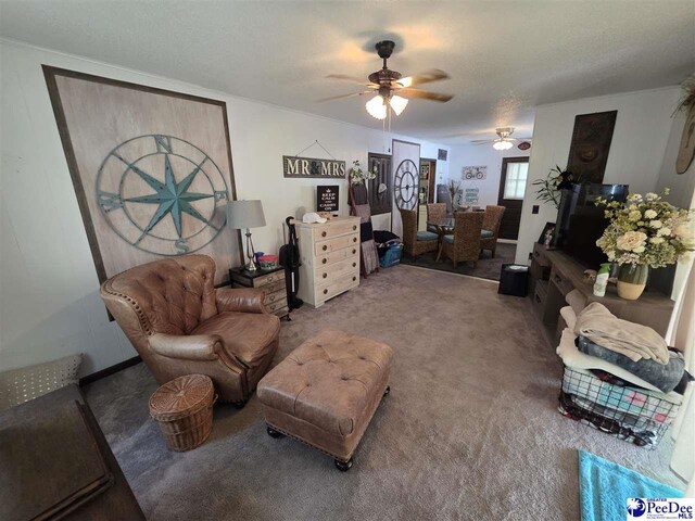 carpeted living room with ceiling fan