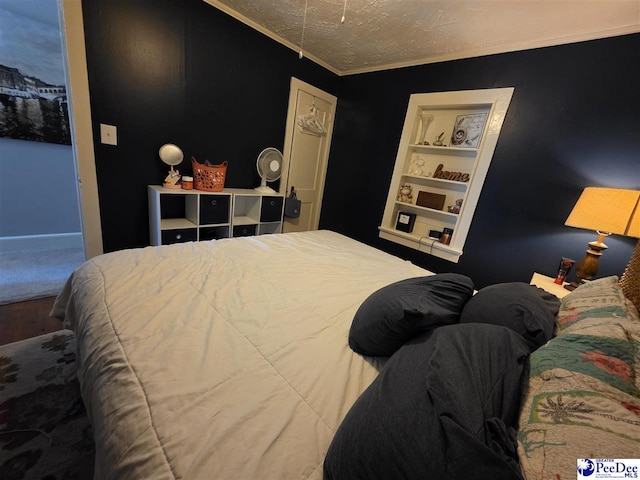 bedroom with ornamental molding and a textured ceiling