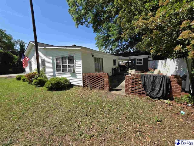 view of home's exterior with a yard