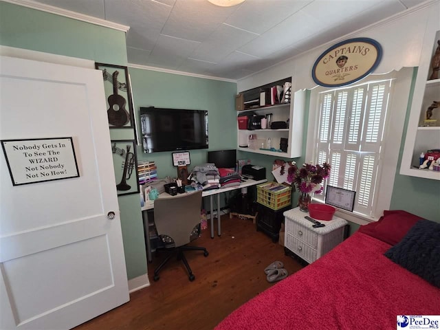 bedroom with wood finished floors and crown molding
