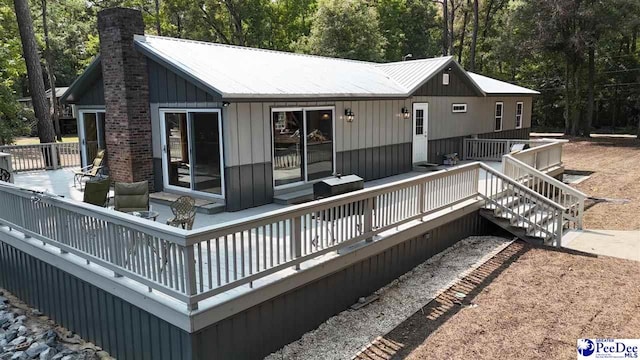 back of property featuring a deck