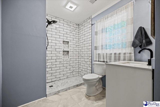 1314 Sewanee Ave, Florence, SC 29501 - bathroom featuring toilet, a tile shower, vanity, and marble finish flooring