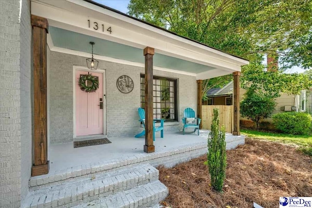 1314 Sewanee Ave, Florence, SC 29501 - doorway to property featuring a porch and brick siding