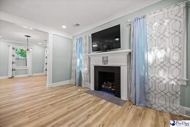 1314 Sewanee Ave, Florence, SC 29501 - unfurnished living room featuring a fireplace, wood finished floors, ornamental molding, a chandelier, and baseboards