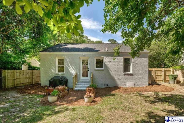 1314 Sewanee Ave, Florence, SC 29501 - rear view of house with entry steps, a fenced backyard, and a shingled roof