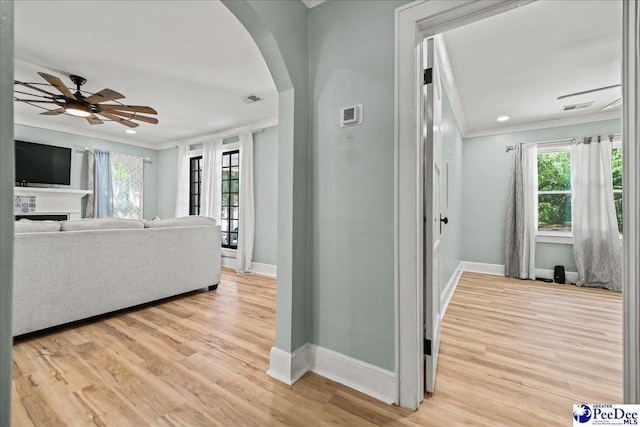 1314 Sewanee Ave, Florence, SC 29501 - hallway with ornamental molding, arched walkways, baseboards, plenty of natural light, and light wood-type flooring