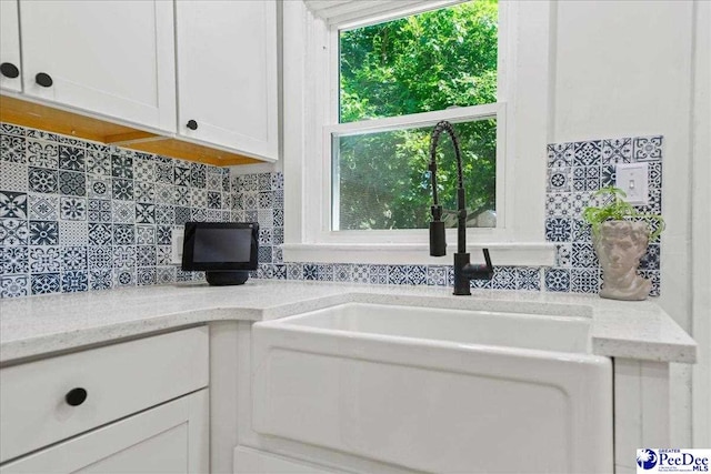 1314 Sewanee Ave, Florence, SC 29501 - kitchen with a sink, white cabinets, tasteful backsplash, and light stone countertops