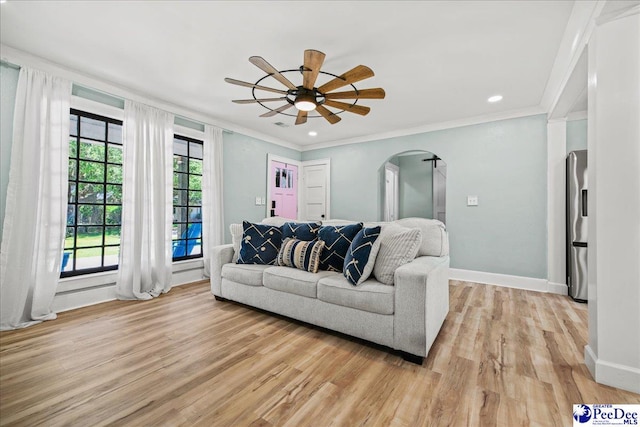 1314 Sewanee Ave, Florence, SC 29501 - living room with arched walkways, light wood-style floors, a ceiling fan, crown molding, and baseboards